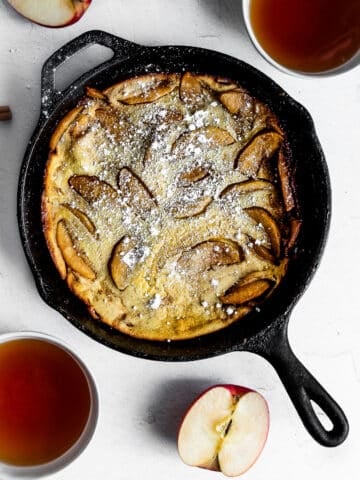 Apple Dutch Baby Pancake Dusted with Powdered Sugar and Served with Tea