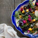 autumn salad on blue serving tray on wooden background