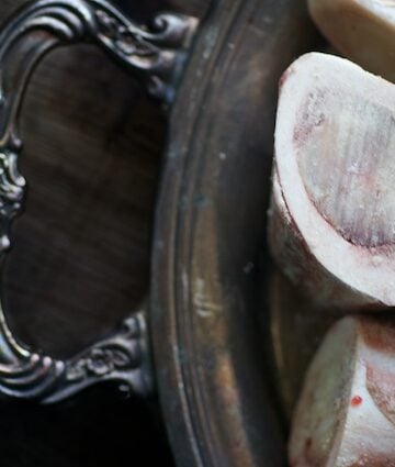 Cross-cut marrow bones on a silver platter.