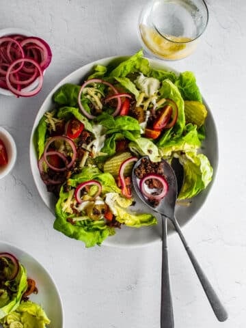burger bowls with lettuce, tomatoes, onions, cheese, pickles and ground beef