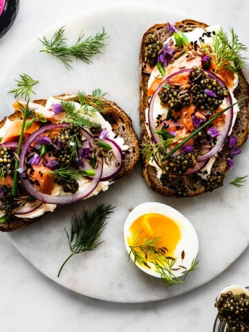 Caviar tartines with dill, chive blossoms and smoked salmon