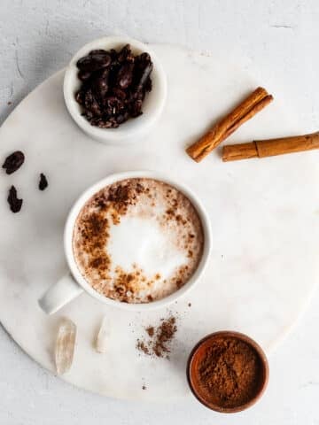 chocolate tea latte in a white mug on a marble surface