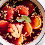 close up of cranberry cider with spices in a pot