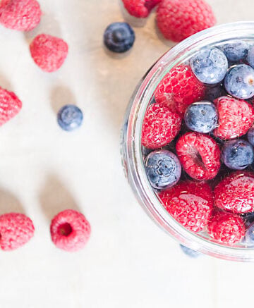 raspberries and blueberries in a jar
