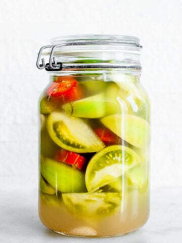 fermented green tomatoes in a jar