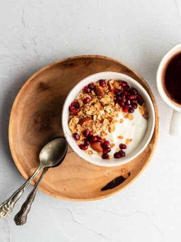 Filmjölk in a bowl, served with muesli and pomegranate seeds