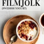 Filmjolk yogurt in a white bowl served with pomegranate seeds and granola