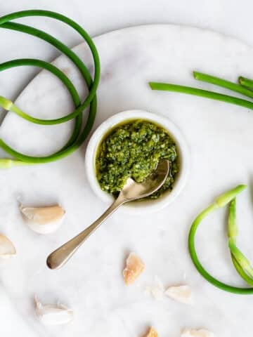 garlic scape pesto on marble surface