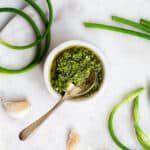 garlic scape pesto on marble surface