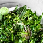 herb salad in a white bowl