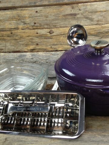 ice cube tray and enameled cast iron pot on wooden background