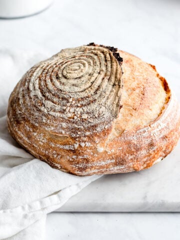sourdough bread on a white background with flower in a container