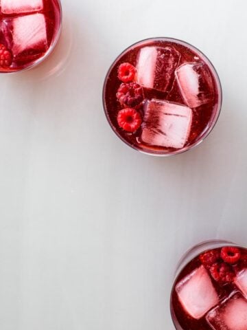 raspberry drink in three cups with ice
