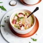 salmon chowder in a bowl garnished with dill