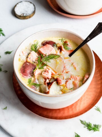 salmon chowder in a bowl garnished with dill