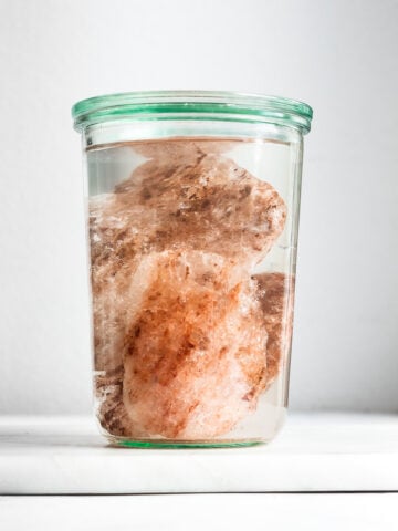 Himalayan pink rock salt in a glass with water