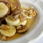 sourdough french toast with walnuts, maple syrup and bananas