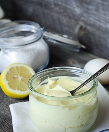 avocado oil mayonnaise in glass jar on wood surface