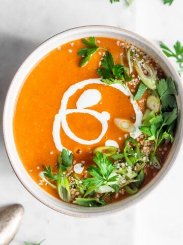 tomato and bean soup garnished with herbs and almonds