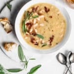 White bean soup garnished with pancetta, sage and rosemary